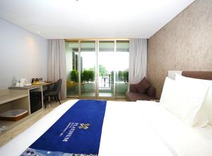 金巴兰Platinum Hotel Jimbaran Beach Bali的配有一张床和一张书桌的酒店客房