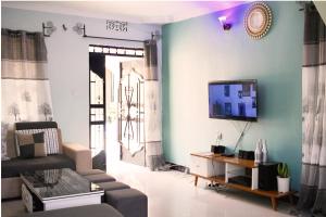 莫希Stay in Bomang'ombe with Breakfast的客厅配有沙发和墙上的电视