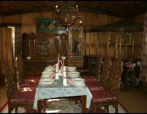 斯利那加Aliflaila Laila Group of Houseboats , Srinagar的一间带长桌和椅子的用餐室
