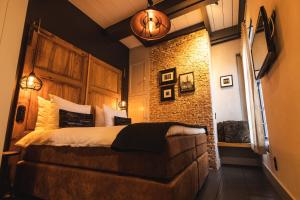 米德尔堡De Koepoort的一间卧室设有一张床和砖墙