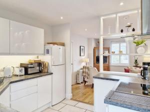 奇切斯特Castleton , Chichester的厨房配有白色橱柜和白色冰箱。