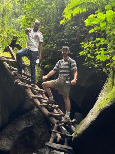 阿鲁沙Safari villa的两个人站在丛林中的一座桥上
