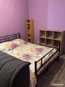 LʼAbergement-de-VareyUN PETIT COIN DE CAMPAGNE的一间卧室配有一张带花卉床罩的床