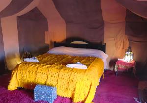 扎古拉Sahara Berber Camp的帐篷内一间卧室,配有一张大床