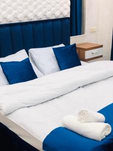 巴统Nana's House的一张带蓝色和白色床单及蓝色枕头的床