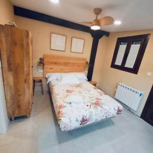 LaukizCaserio Kamirune的一间卧室配有一张带木制床头板的床