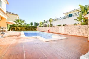 阿尔坎塔里利亚Vila com piscina a 5 minutos da Praia的庭院中带游泳池的房子