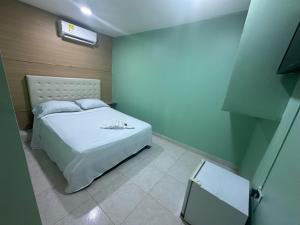 卡塔赫纳HOTEL NUEVO ARIZONA的卧室配有白色的床