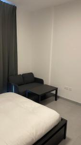 沙迦Al jada / Reef 4的客房设有床、沙发和桌子。
