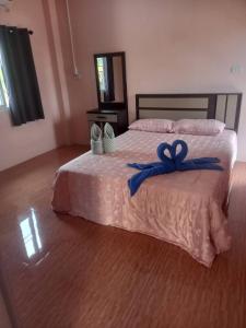 Ban Saiyuan (1)Phujhaofa villa club ( ไสยวน)的一间卧室配有一张带蓝色丝带的床