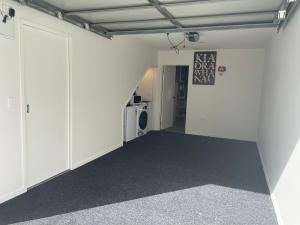 奥克兰Auckland CBD, Parnell Ensuite+Patio+Secluded Garage的一间空房间,有白色的墙壁和门