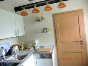 Ferienhaus Schöne的厨房配有厨房台面上的橙色灯