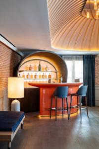 马德里Casa Faraona Luxury Residences的一间酒吧,房间配有两把椅子和一张桌子