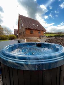 DuneenaLarge Newly Refurbished Lakeside Chalet With Optional Hot Tub & Boat Hire的房屋前的大型热水浴池