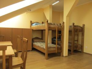 乌日霍罗德Mini-hotel Na Pidgradskiy的带桌子的客房内的两张双层床