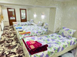撒马尔罕HOTEL-129的紫白色客房的两张床