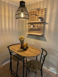 奥勒松Apartment close to Aalesund center的一张带椅子和吊灯的木桌