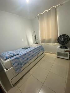 巴西利亚Samambaia QI 616的白色卧室配有床和风扇