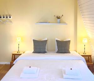 阿灵厄散库斯贝德酒店的卧室配有一张带两个枕头的大白色床