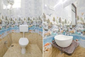 纳西克FabHotel Blue Ocean MNJ Resort的一间带水槽、卫生间和壁画的浴室