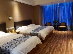ZhuanwachangSuper 8 Hotel Changchun Jingyue Xincheng Street Bashu Yingxiang的两张位于酒店客房的床,配有蓝色窗帘