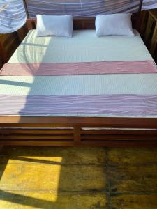 阿鲁甘湾Surf Beach Hotel的一张木架床