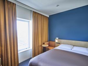泉佐野关西机场华盛顿酒店的酒店客房设有床和窗户。