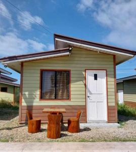 Lapu Lapu CityBungalow House-Olango Island的一间小房子,配有一张野餐桌和两张木柴