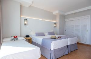 贝纳尔马德纳伊斯迪瓦托克布拉德酒店的白色墙壁客房的两张床