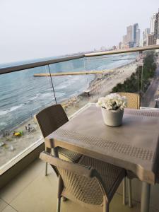 卡塔赫纳Palmetto Beach Cartagena vista de frente al mar的海滩景阳台配有桌椅