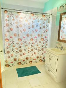 库尔克岛JAGUAR MORNING STAR的浴室内带贝壳和水槽的浴帘