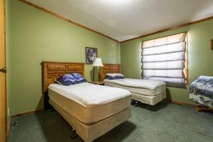 Neillsville6 Guests 3br, Fully Furnished, On-site Enjoyment的一间卧室设有两张床和窗户。