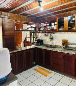 格拉瓦塔Casa de Campo em Gravatá super aconhegante的一个带木制橱柜和水槽的厨房
