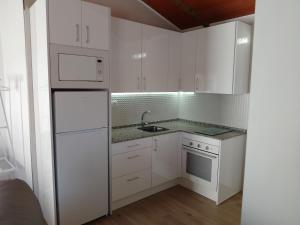 阿达莱斯Apartamento Isabel的白色的厨房配有白色橱柜和水槽