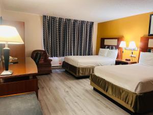艾恩芒廷Mountain Inn的酒店客房配有两张床和一张书桌