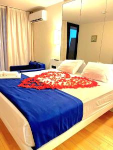 巴统ORBI CITY batumi的一间卧室配有一张红色鲜花的大床