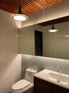 Thung Song356 Hostel的一间带卫生间、水槽和镜子的浴室