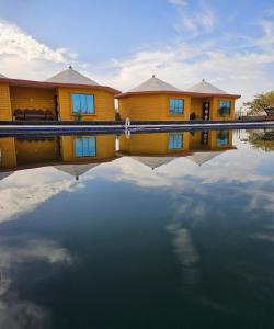 斋沙默尔Luxury The Sunrise Resort with swimming pool Jaisalmer的前面有水池的房子