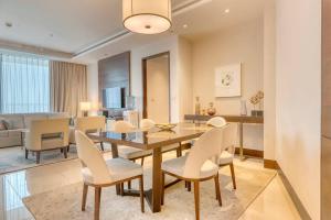 迪拜Address Sky View Tower 2 - Luxury 3Beds + Maids的用餐室以及带桌椅的起居室。