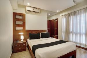 班加罗尔Super Townhouse Koramangala的一间卧室设有一张大床和一个窗户。
