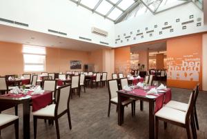 俄斯特拉发俄斯特拉发克拉丽奥酒店的一间在房间内配有桌椅的餐厅