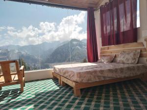 马恩迪Stargazing Glass Lodge Himachal Pradesh Thachi的一间卧室设有一张床和一个大窗户