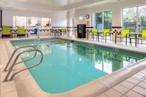 波特兰波特兰机场春季山丘套房酒店的酒店大堂设有桌椅的游泳池