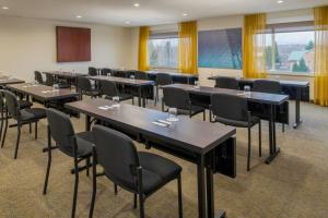 波特兰波特兰机场春季山丘套房酒店的一间会议室,配有桌椅和窗户