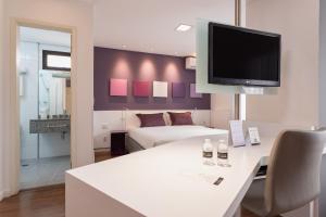 圣保罗Paulista Suites by Charlie的客厅配有白色桌子和电视