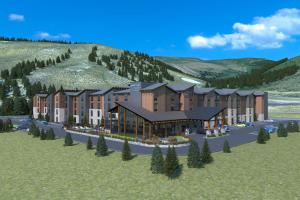 埃文TownePlace Suites by Marriott Avon Vail Valley的山 ⁇ 的建筑的 ⁇ 染