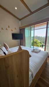 Ban Thap SaiSoidao Good View Resort的一间卧室设有一张大床和大窗户