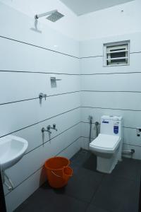 埃尔讷古勒姆AIRPORT COCHIN ROYAL RESIDENCY的浴室配有白色卫生间和盥洗盆。