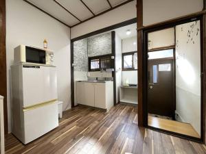 大阪TSUBAME 101 staying private home的厨房配有冰箱和水槽