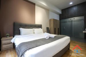 吉隆坡Astoria Ampang By Grabstay的一间卧室配有一张带白色床单的大床